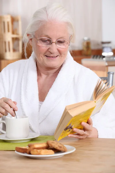 Ältere Dame genießt Tee und Kekse — Stockfoto
