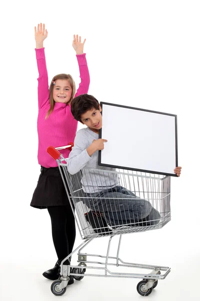 Two kids with trolley — Stock Photo, Image