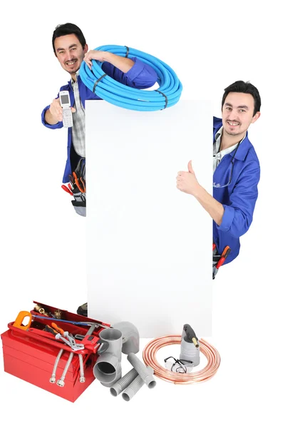 Two workers stood with blank poster — Stock Photo, Image