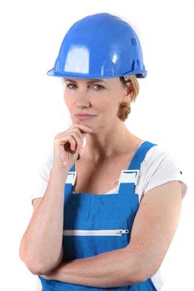 Woman with helmet and hand on chin — Stock Photo, Image