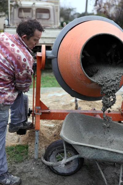 Construtor usando um misturador de cimento — Fotografia de Stock