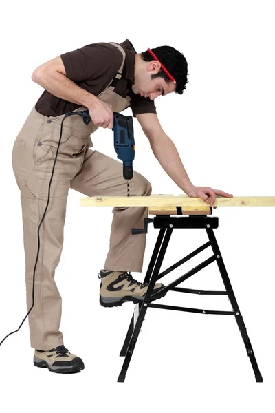 Carpenter drill through plank of wood — Stock Photo, Image