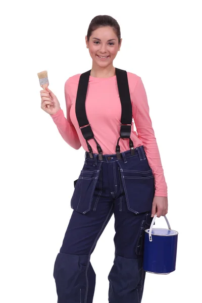 Woman holding a paintbrush and can of paint Stock Image