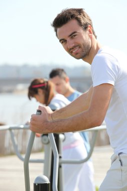 Man doing gymnastics in urban space clipart