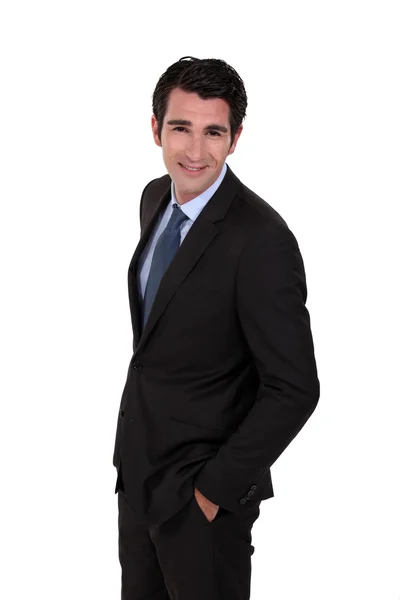 Confident businessman with hands in pockets — Stock Photo, Image