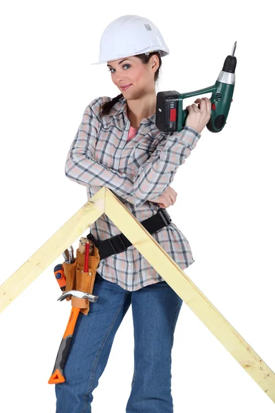 Woman with a drill and a frame — Stock Photo, Image