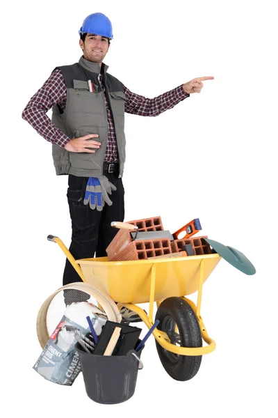 Mason by wheelbarrow full of equipment — Stock Photo, Image