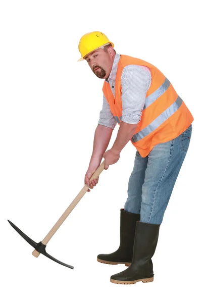 Construction worker with pickaxe on white background — Stock Photo, Image