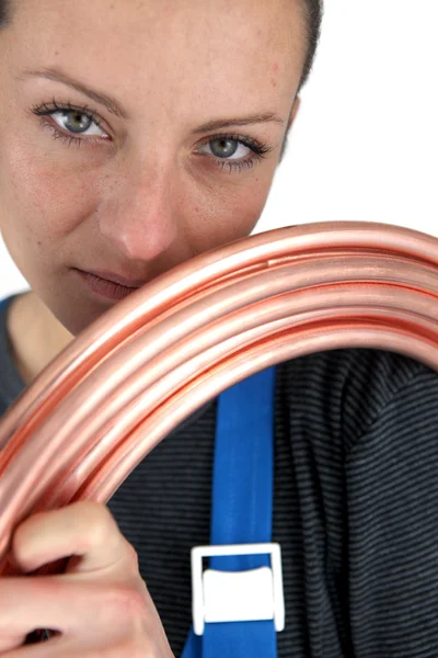 Portrait of woman with copper pipe — Stock Photo, Image