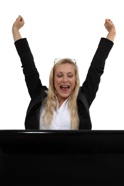 Excited blond businesswoman with laptop — Stock Photo, Image
