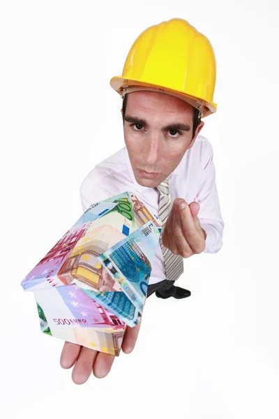 Architect with a house made of money — Stock Photo, Image