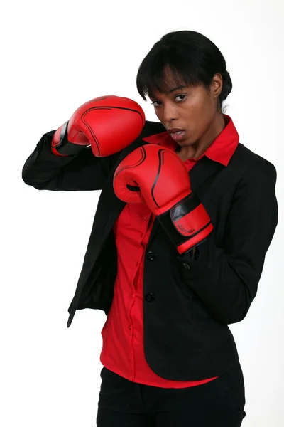 stock image Businesswoman wearing boxing gloves