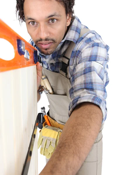 Carpenter with a spirit level Royalty Free Stock Images