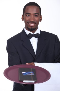 Smart waiter with the bill and a credit card clipart