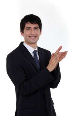 Smiling businessman clapping his hands clipart