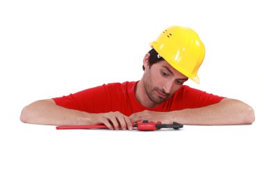 Man playing with a pipe wrench clipart