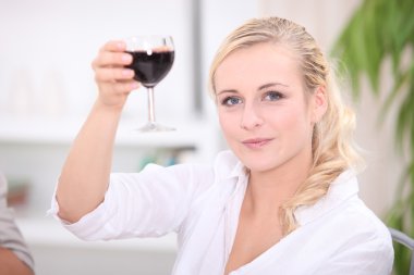 Woman toasting with red wine clipart