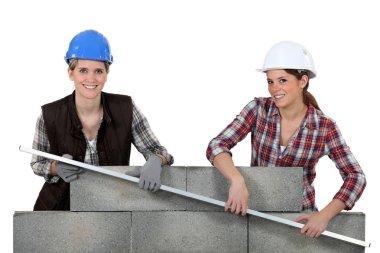 Female construction workers lifting a bar clipart