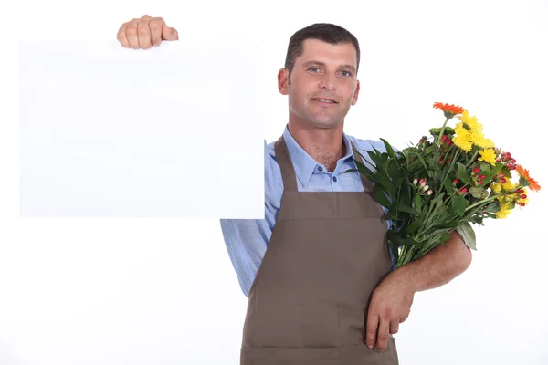 Чоловічий флорист з купою квітів — стокове фото