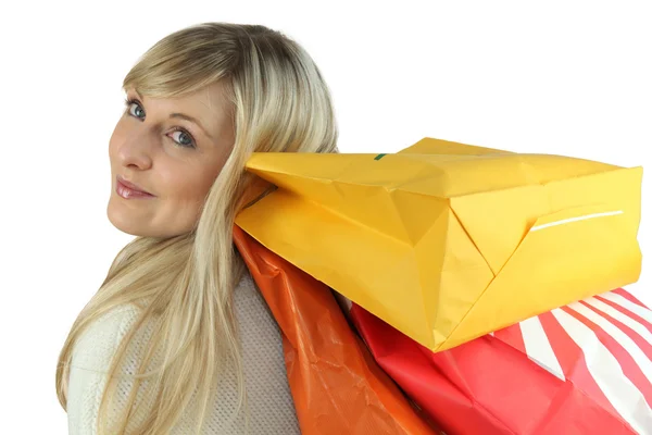 Sarışın bir kadın alışveriş çantaları taşırken — Stok fotoğraf