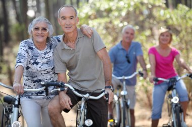 Elderly riding their bikes clipart