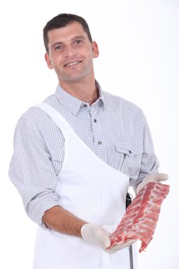 A butcher showing pork ribs clipart