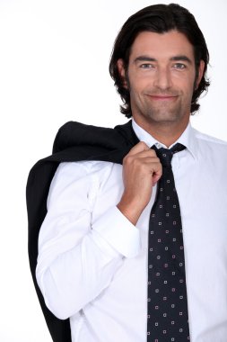 Smiling businessman with his jacket over his shoulder clipart