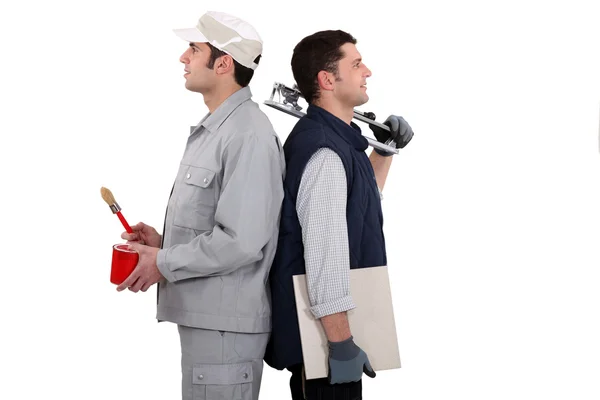 Painter and tiler back to back — Stock Photo, Image
