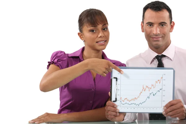 Business couple pointing at graph — Stock Photo, Image