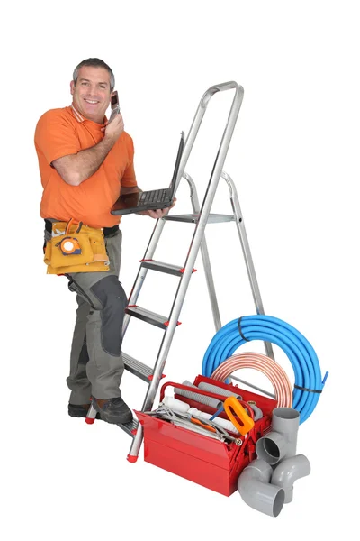 Plumber on the phone with computer — Stock Photo, Image