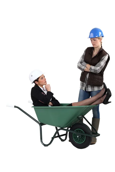 Unhappy tradeswoman distraught at finding an engineer in her wheelbarrow — Stock Photo, Image