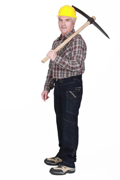 Mature man with a pickaxe — Stock Photo, Image