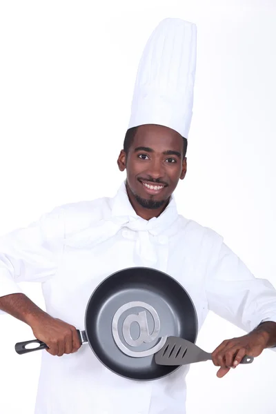 Cook holding pan with email symbol — Stock Photo, Image