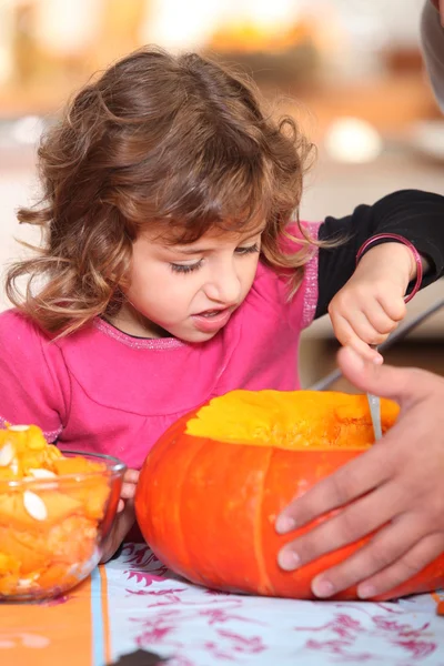 Girl pouring pumpkin — Stock Photo, Image