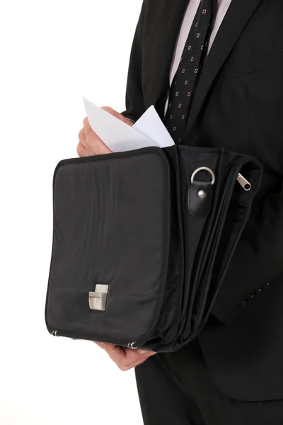 Man removing document from briefcase — Stock Photo, Image