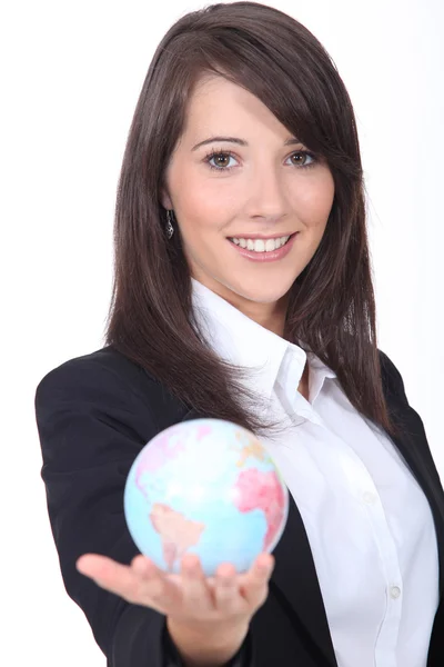 Portrait of a young woman holding a globe — Stock Photo, Image