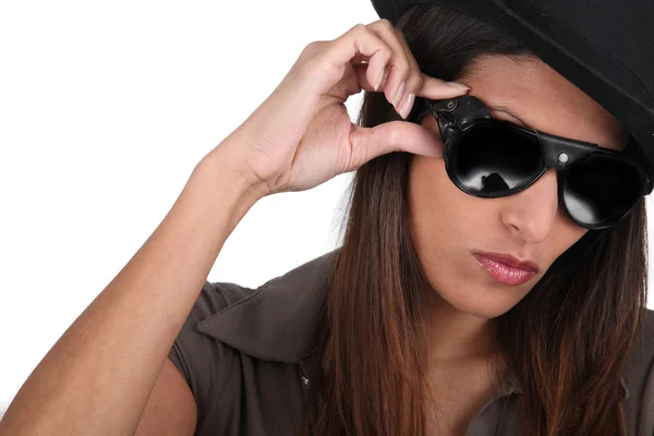 Cool brunette in sunglasses and a hat Stock Picture