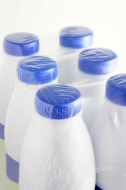 Six plastic bottles of milk clipart