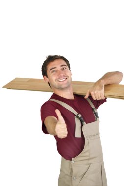 Elated carpenter giving the thumb's up clipart