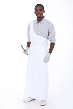 Full length studio portrait of a butcher with apron and knife clipart