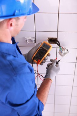 Electrician with a voltmeter clipart