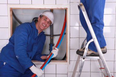 Workers installing a water system clipart