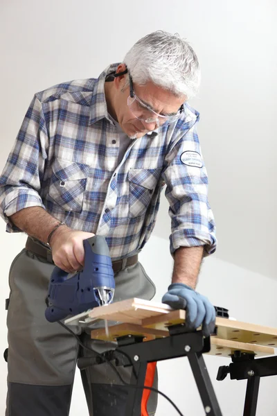 Tradesman using a jigsaw — Stock Photo, Image