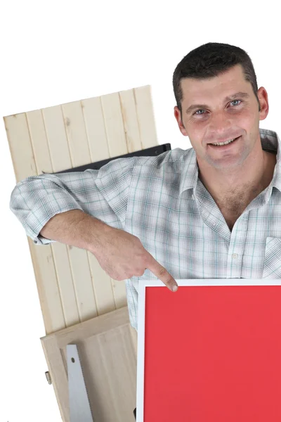 Joiner pointing to red poster board — Stock Photo, Image
