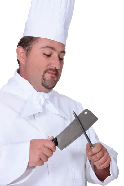 Chef sharpening meat cleaver — Stock Photo, Image