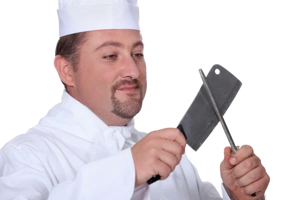 Chef sharpening a knife — Stock Photo, Image
