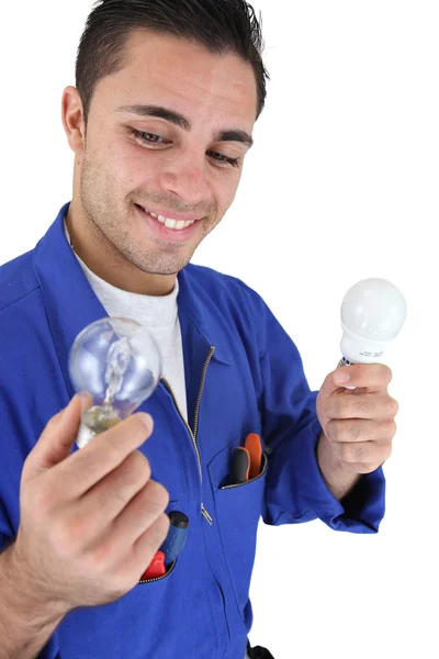 Electrician holding light bulbs Stock Photo