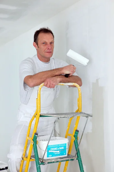 Painter stood on ladder Royalty Free Stock Images
