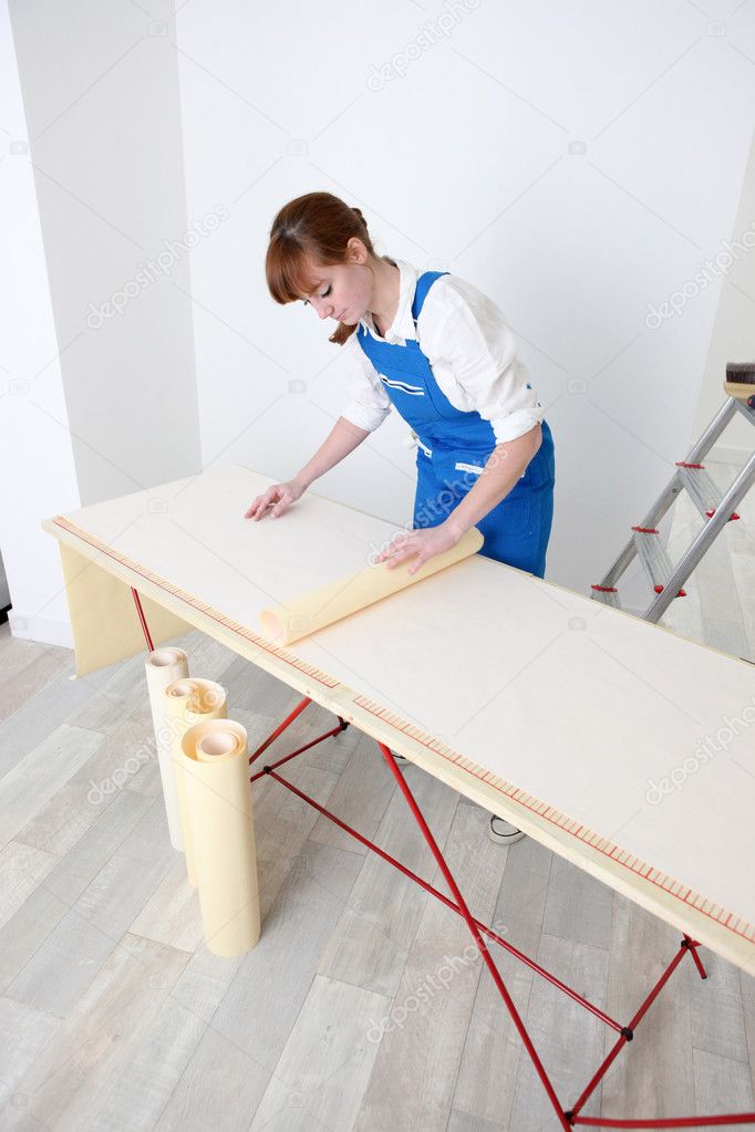 Woman pasting wallpaper Stock Photo by ©photography33 9670759