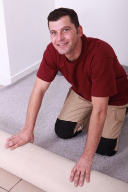 Horizontal image of a man laying carpet clipart